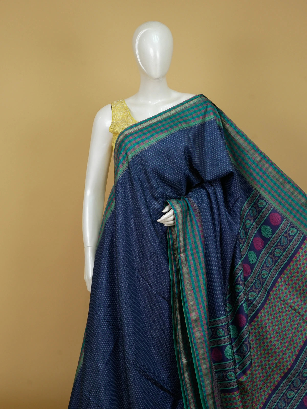 Navy blue Dola silk saree with teal-green contrast checked border and paisley motif pallu