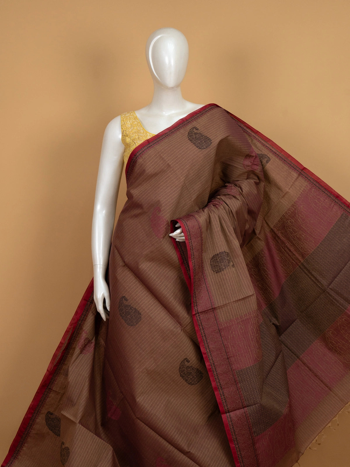 Brown and maroon semi raw silk saree with woven paisley motifs and contrast border