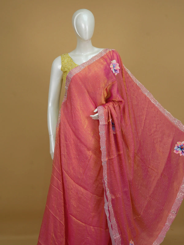 Pink and gold designer tissue saree with scattered stone work, multicolour floral prints and a stone-studded scalloped border.
