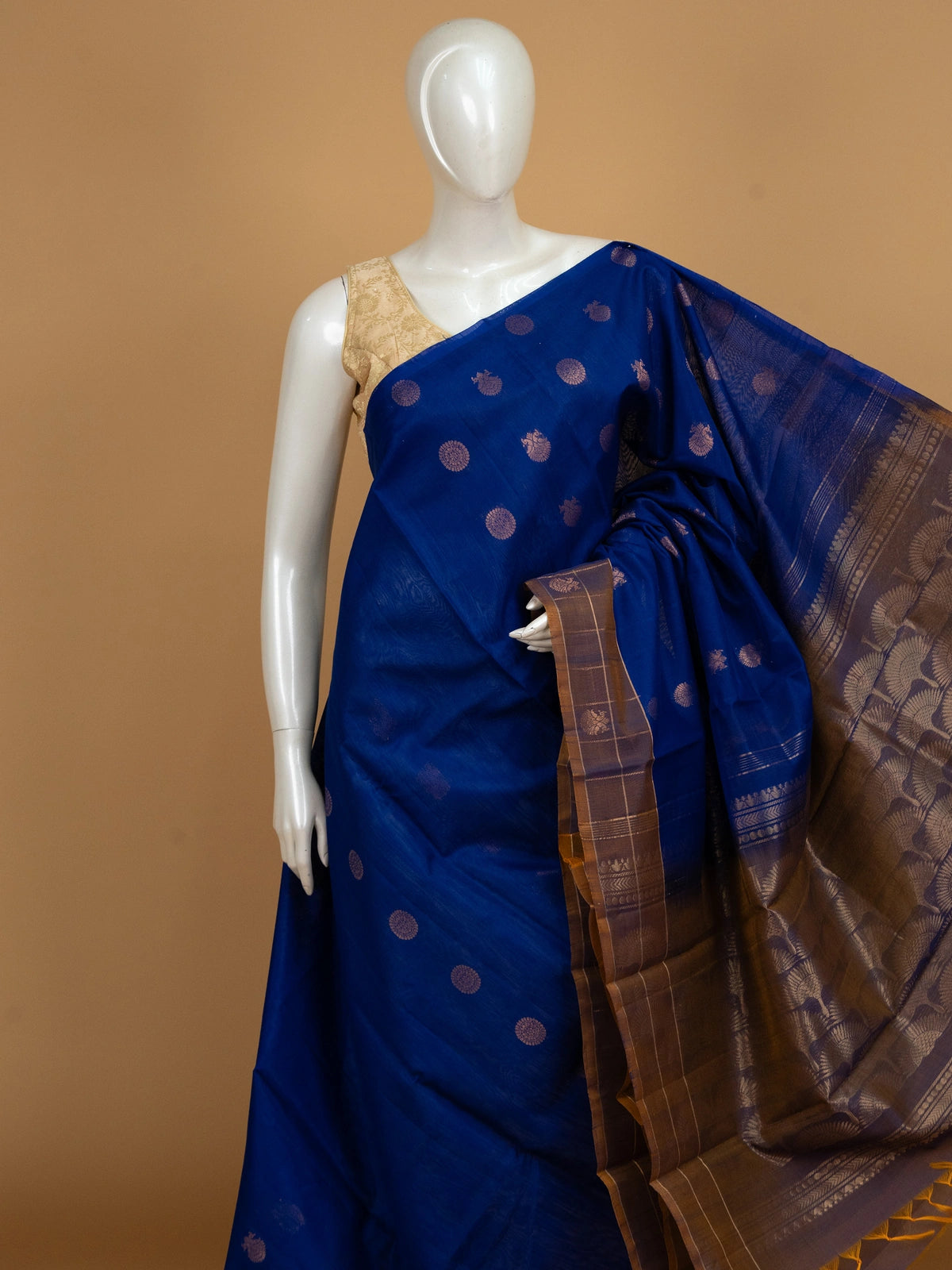 Royal blue pure silk cotton saree with copper-gold zari peacock buttas and contrast border