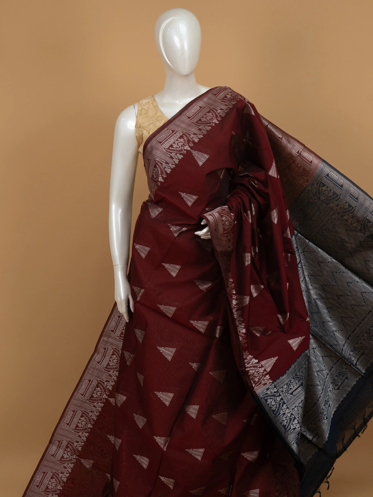 Maroon silk cotton saree with silver zari triangular motifs and contrast navy blue zari border and pallu