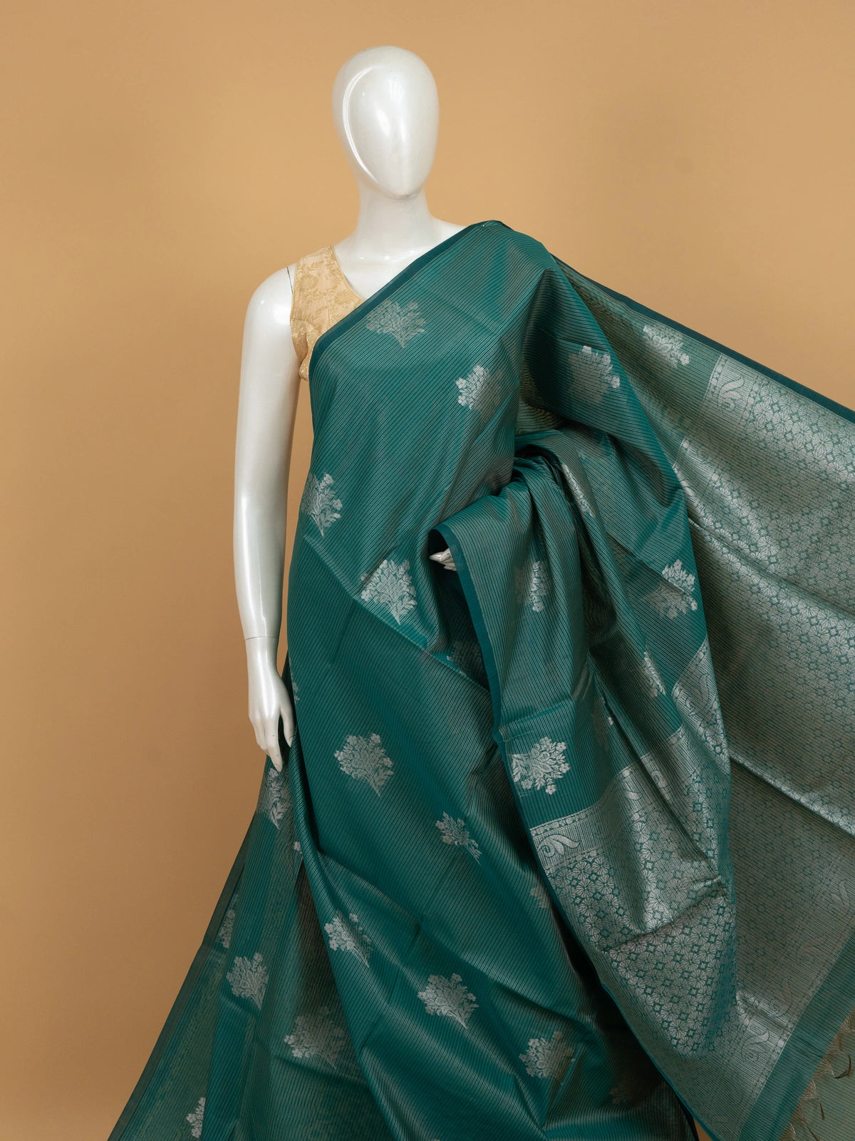 Teal green silk cotton saree with silver zari floral butta and ornate zari pallu