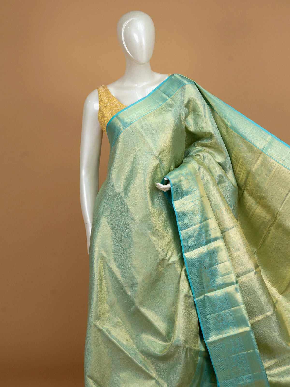 Pista green pure Kanchipuram silk saree with gold zari brocade body and turquoise blue contrast border