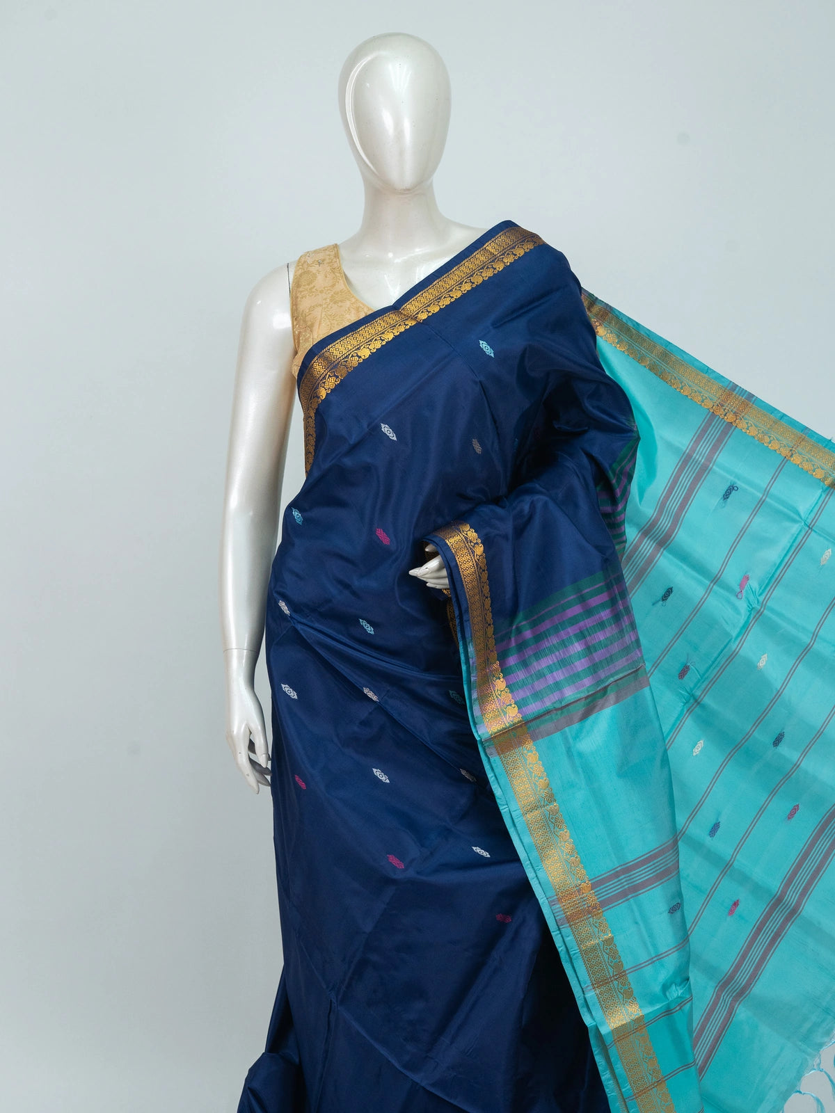 Navy blue Banana Silk saree with gold zari border, multicoloured buttis and contrast turquoise striped pallu