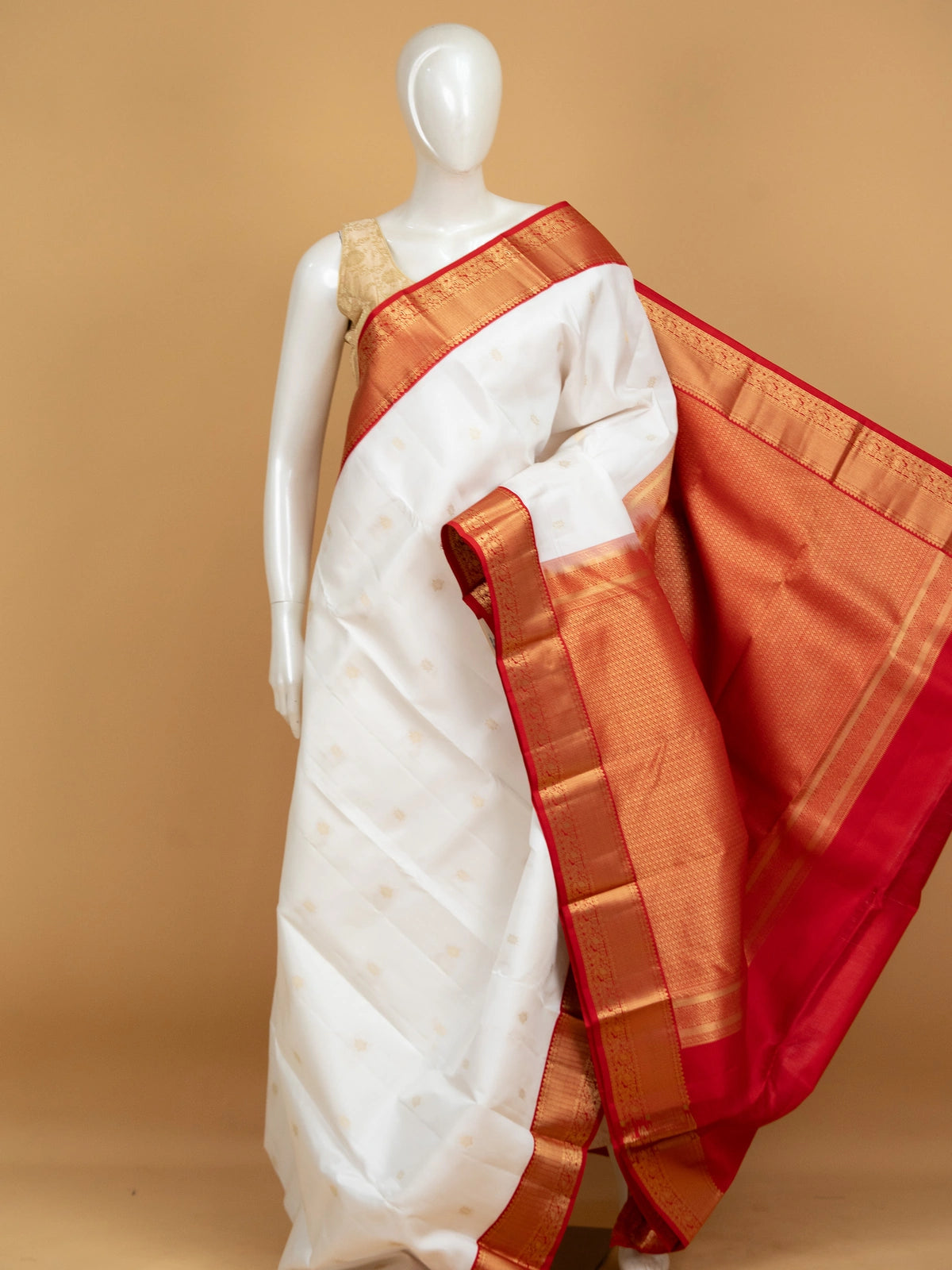 White pure Kanchipuram silk saree with contrast red border and gold zari buttas and pallu