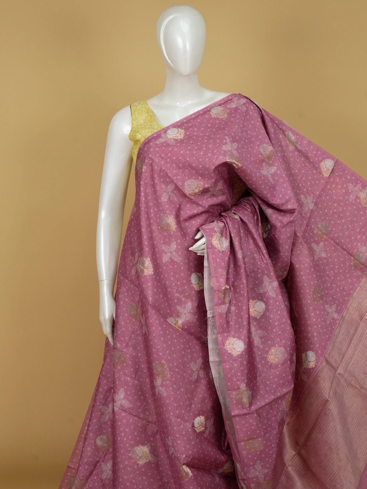 Rose pink designer saree with bandhani-effect texture, gold zari floral buttas and a zari tissue border