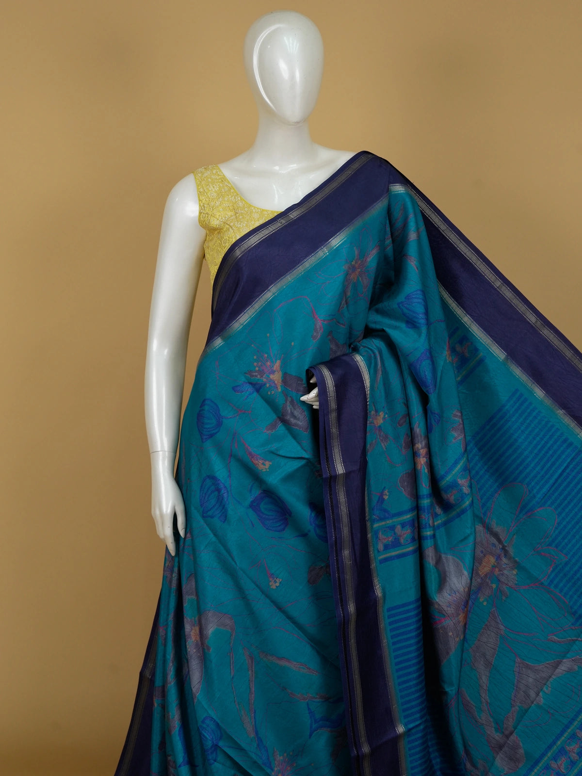 Teal blue Dola silk saree with floral prints, contrast navy zari border and yellow blouse