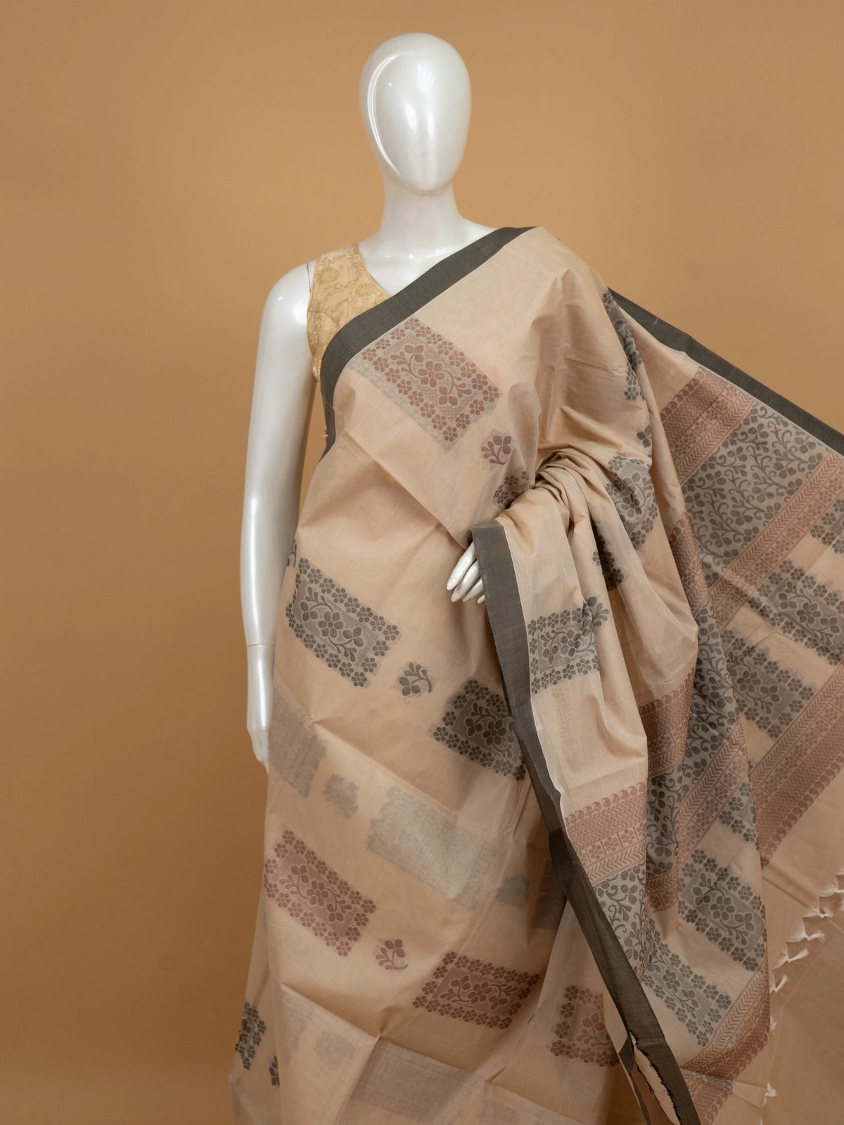 Beige silk cotton saree with grey contrast border and woven floral motifs