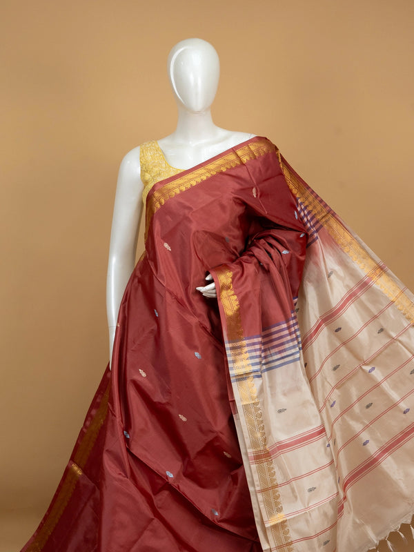 Maroon banana silk saree with gold zari border and contrast cream striped pallu
