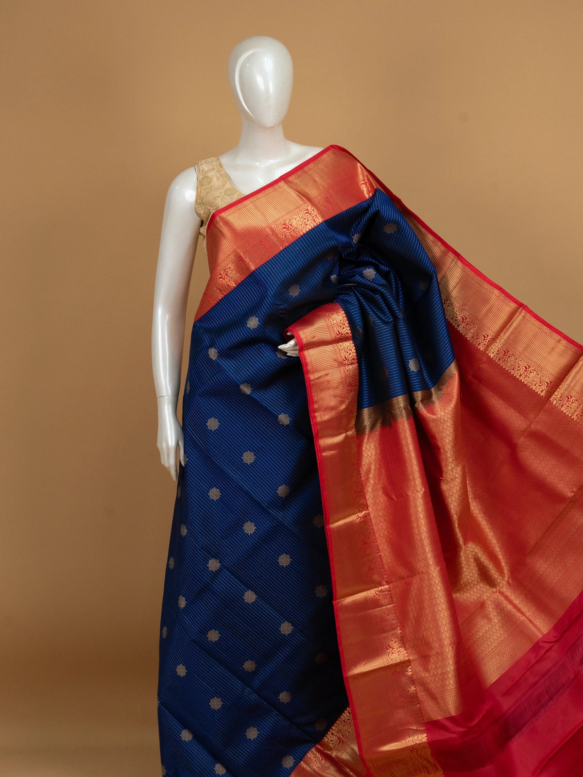 Navy blue pure Kanchipuram silk saree with gold zari stripes, floral buttas and contrast red gold zari border