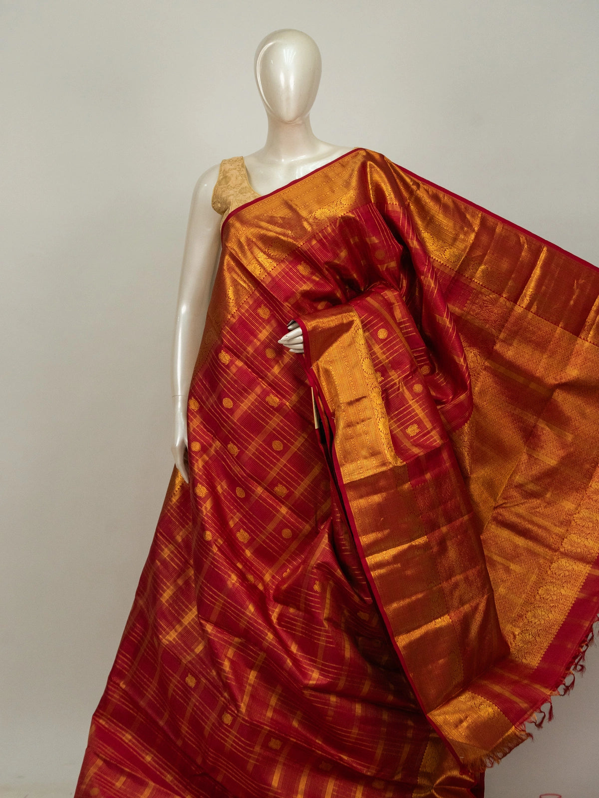 Red and gold pure Kanchipuram silk saree with checked body, gold zari buttas and ornate temple zari border