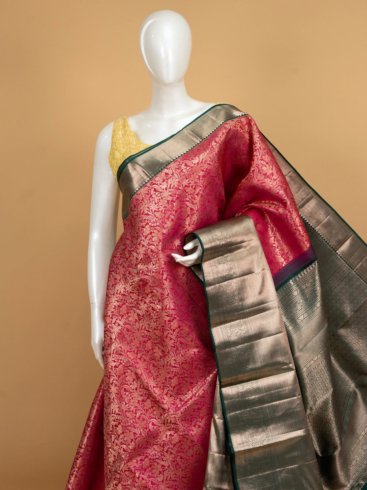 Rani pink pure Kanchipuram silk saree with green contrast border and gold zari floral jaal