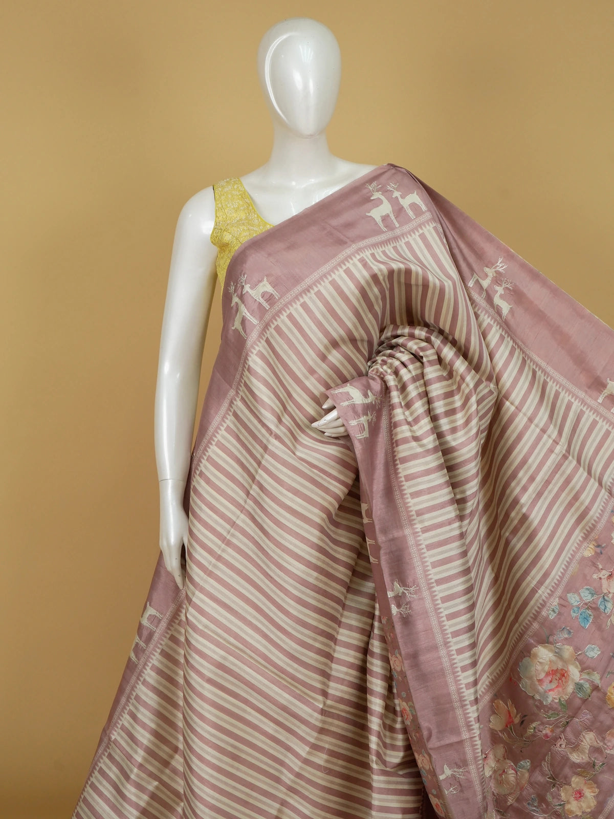 Dusty pink and cream designer silk saree with deer motifs and floral embroidered pallu