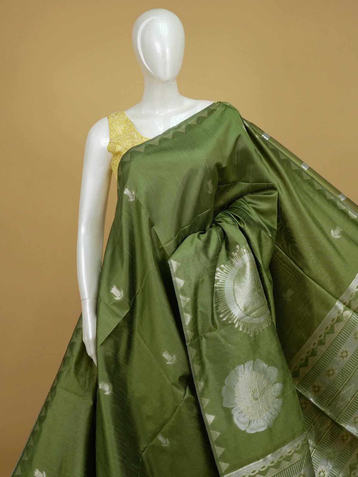 Olive green semi tussar saree with silver zari floral motifs and temple border