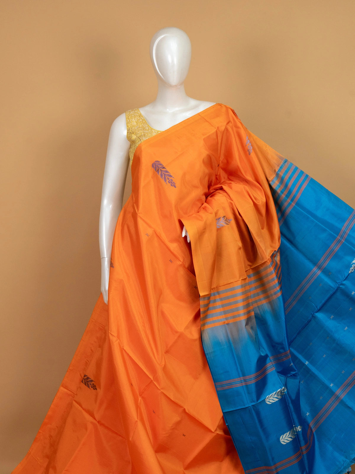 Orange banana silk saree with contrast blue pallu, woven buta motifs and silver zari leaf border