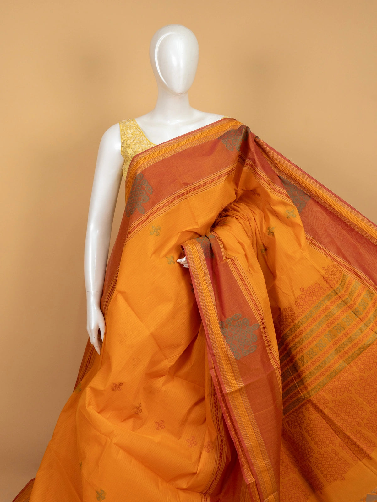 Mustard semi raw silk saree with contrast rust border and kolam-motif pallu