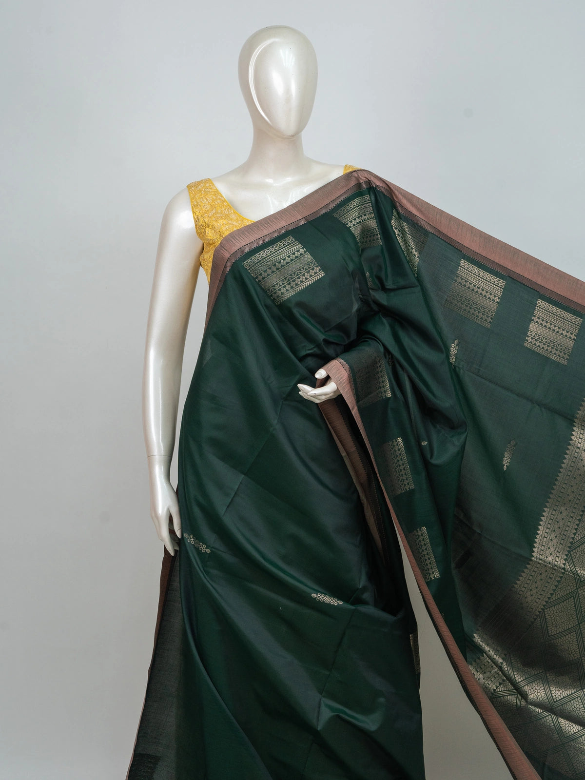 Bottle green semi silk saree with copper contrast border and gold zari pallu