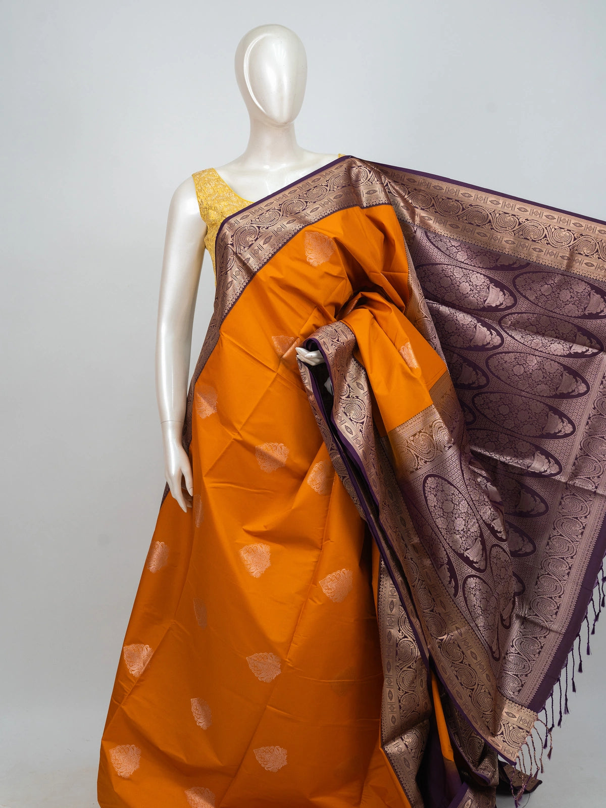 Mustard semi silk saree with contrast purple gold zari border, zari buttas, and ornate woven pallu