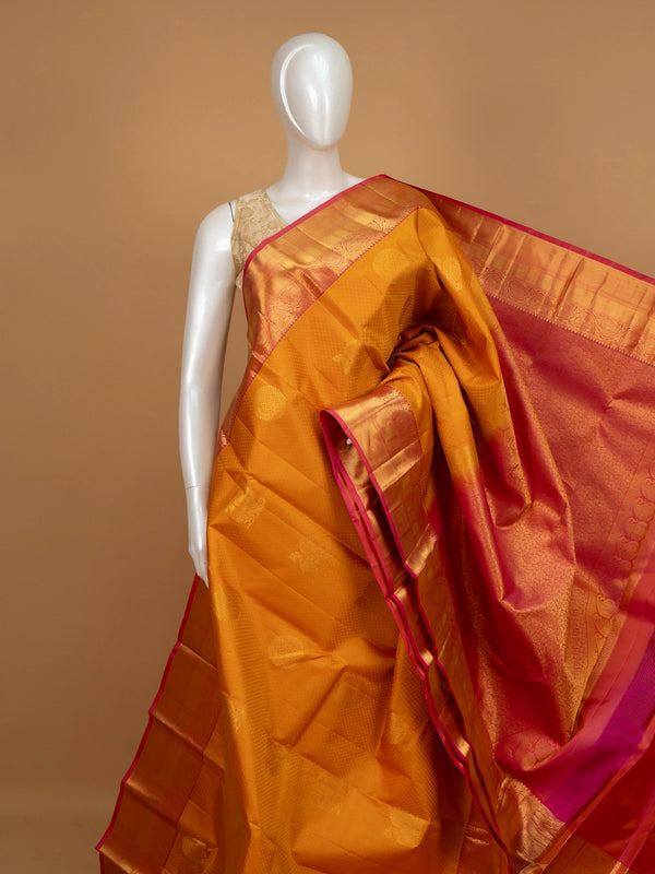 Mustard mustard pure Kanchipuram silk saree with contrast pink gold zari border and zari pallu
