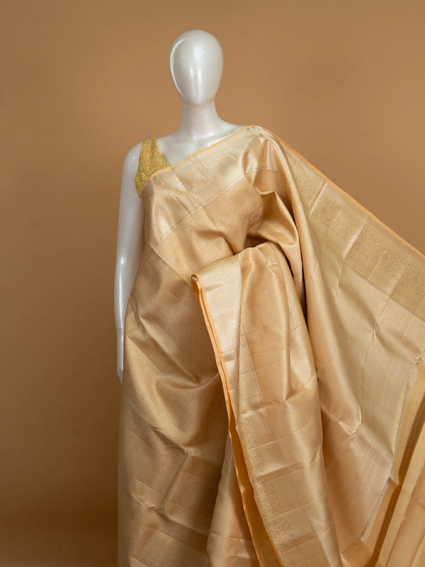 Gold and beige pure Kanchipuram silk saree with all-over gold zari weave and broad floral border