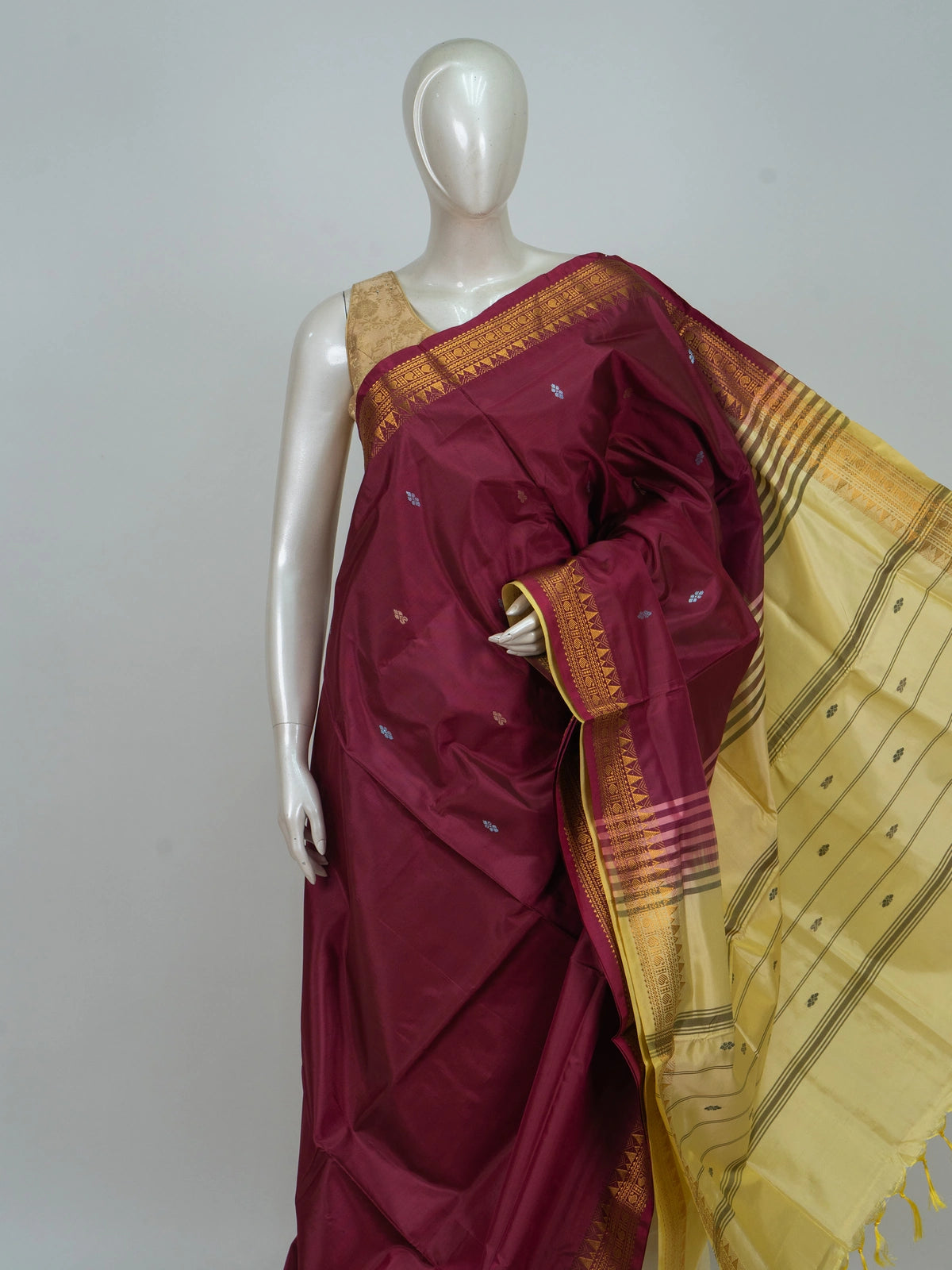 Maroon Banana silk saree with gold zari border, woven buta motifs and contrast cream pallu