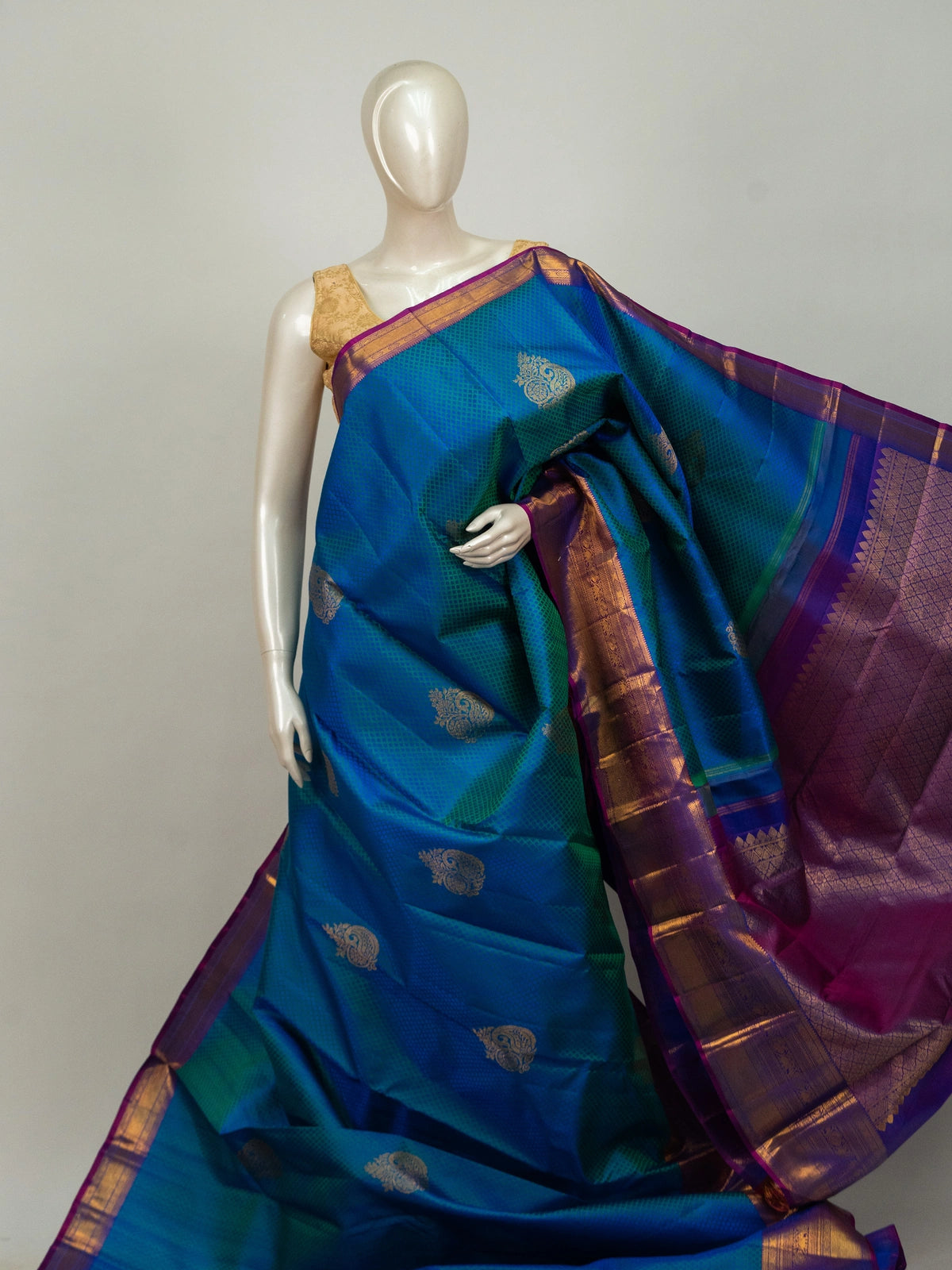 Peacock blue pure Kanchipuram silk saree with contrast purple gold zari border and paisley buttas