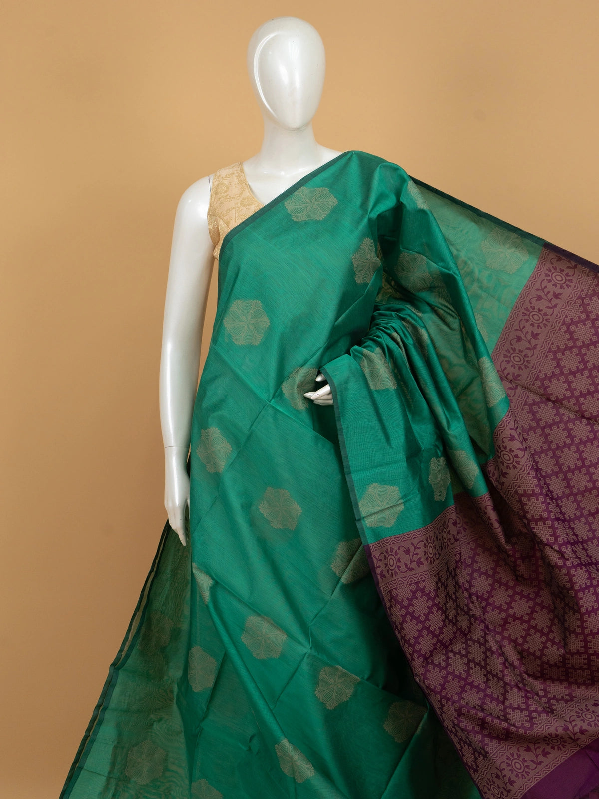 Teal green silk cotton saree with cream floral buttas and contrast purple woven border and pallu