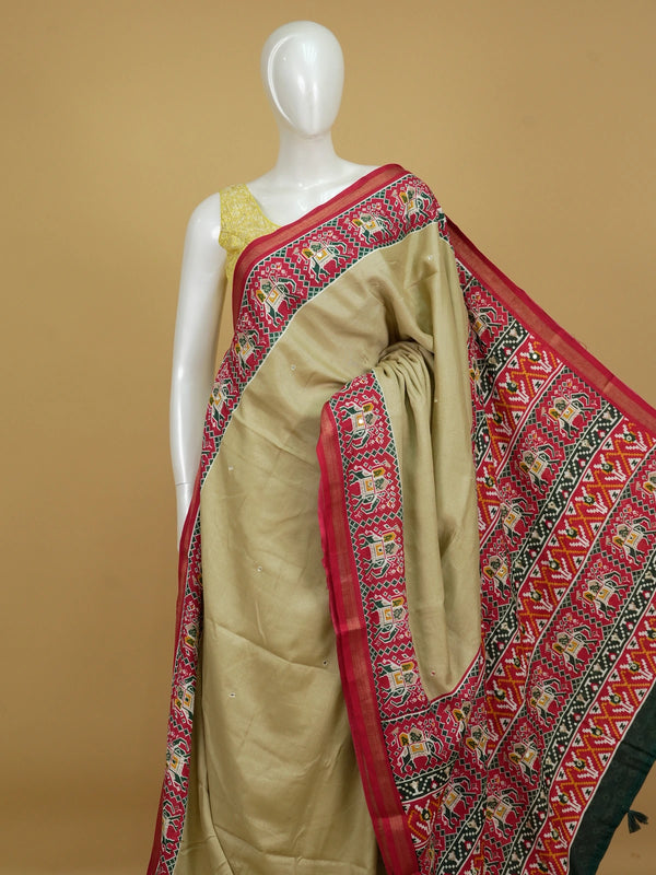 Beige linen cotton saree with red patola-print elephant motif border and pallu