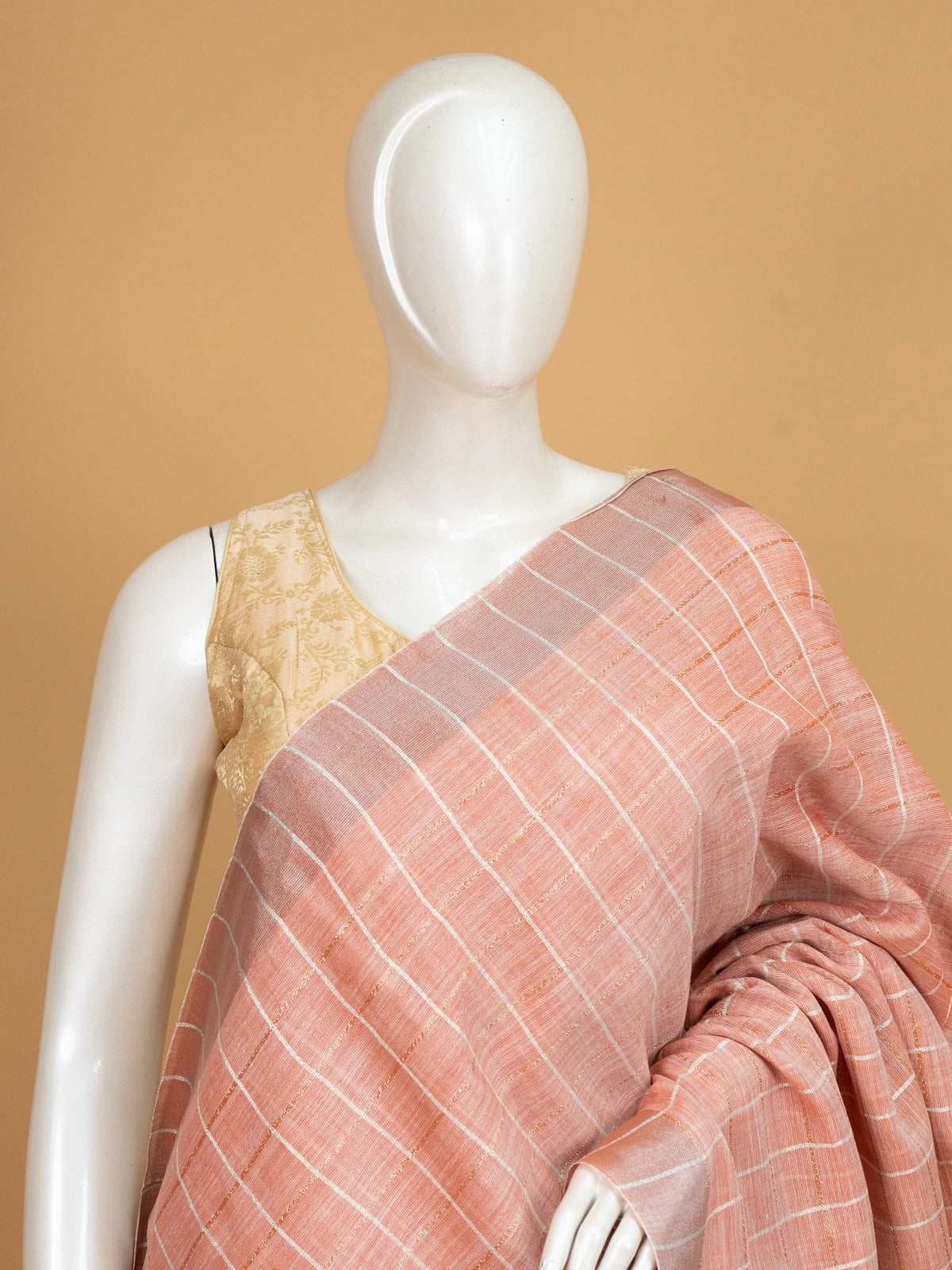 Peach linen cotton saree with white and gold zari checks and contrast striped border