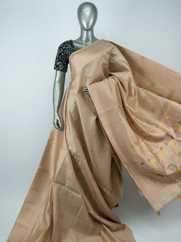 Beige semi raw silk saree with copper zari border and multicolour floral meenakari pallu