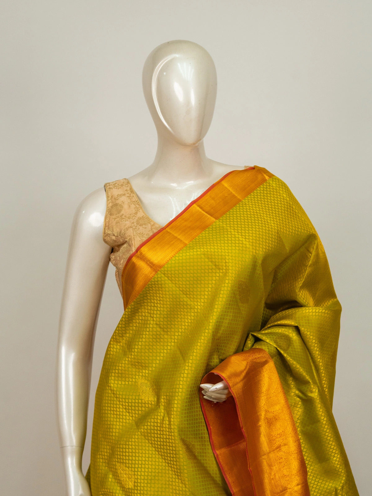 Lime green pure Kanchipuram silk saree with contrast orange gold zari border and pallu