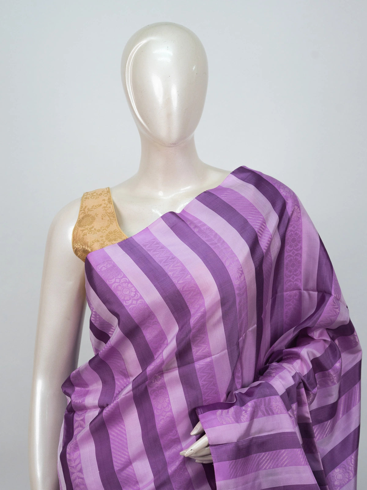 Purple striped soft silk saree with contrast teal pallu, gold zari buttis and tasselled edge