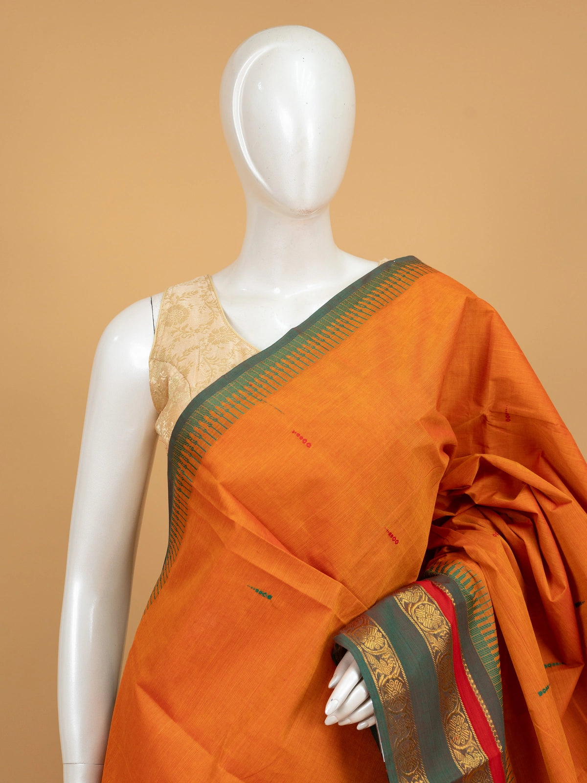 Orange Chettinad cotton saree with contrast green and gold zari border and woven buttas