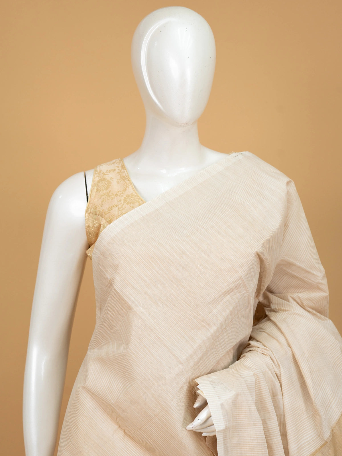 Cream and gold silk cotton saree with striped body, golden zari border and striped pallu