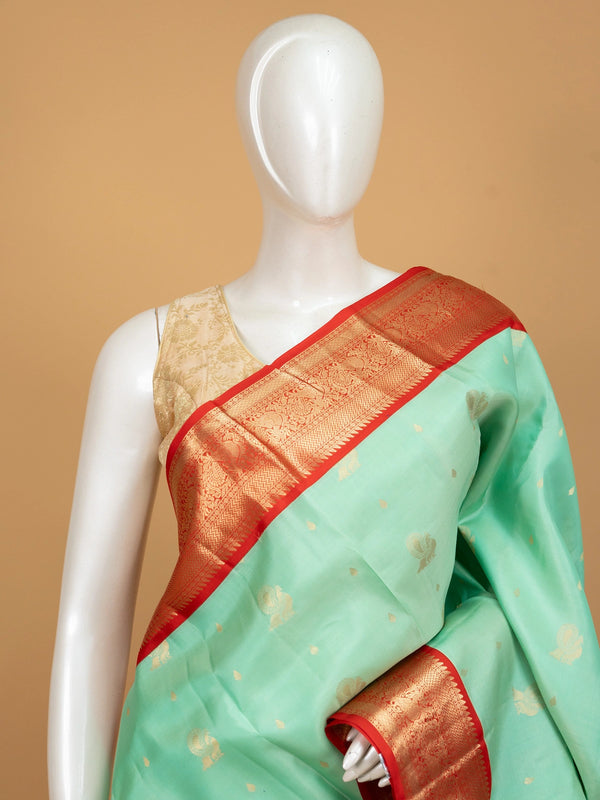 Sea green pure Kanchipuram silk saree with contrast red border, gold zari peacock motifs and richly woven pallu