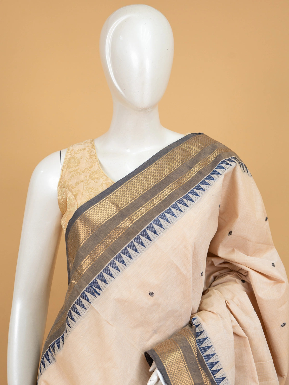 Cream Chettinad cotton saree with navy blue temple border and gold zari