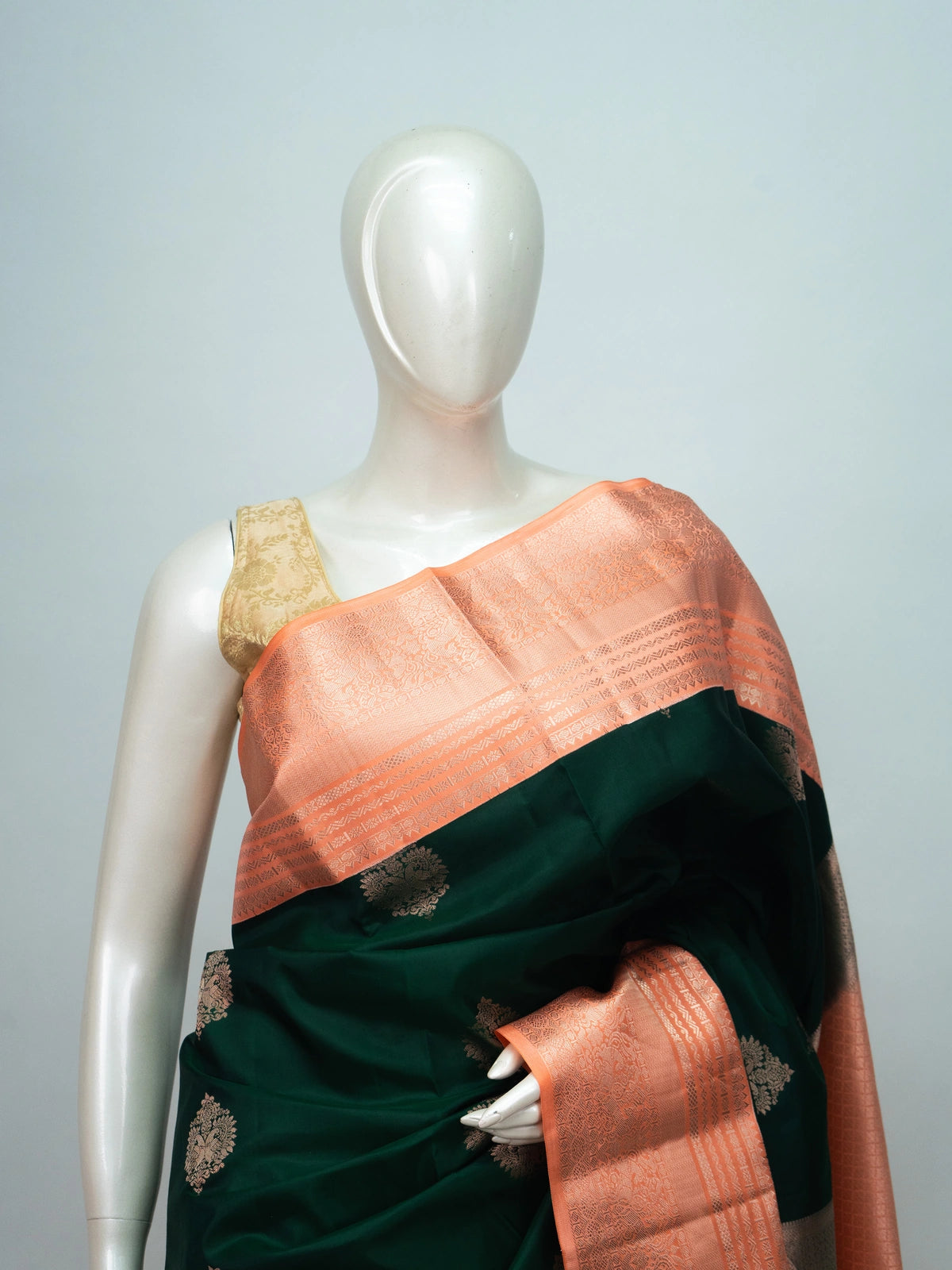 Bottle green pure Kanchipuram silk saree with contrast peach copper-zari border and pallu