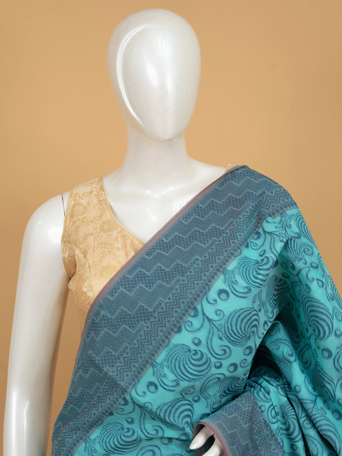 Teal blue silk cotton saree with woven swirl motifs and contrast magenta pink border and pallu