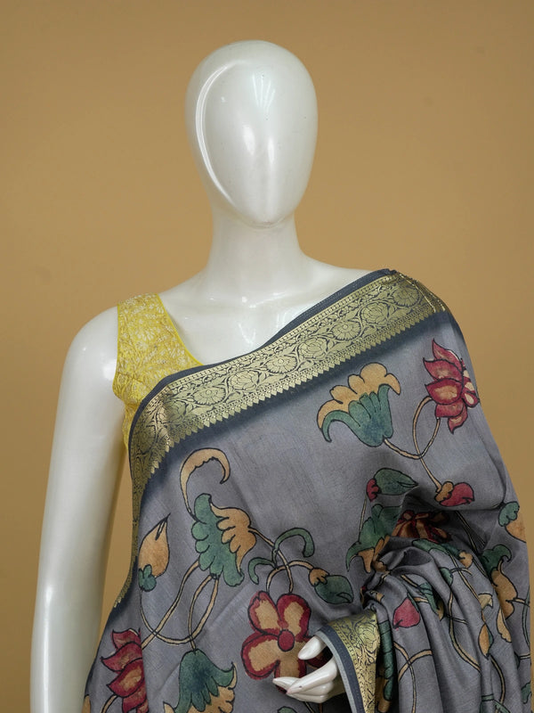 Grey semi tussar saree with Kalamkari floral print, peacock pallu and gold zari contrast border