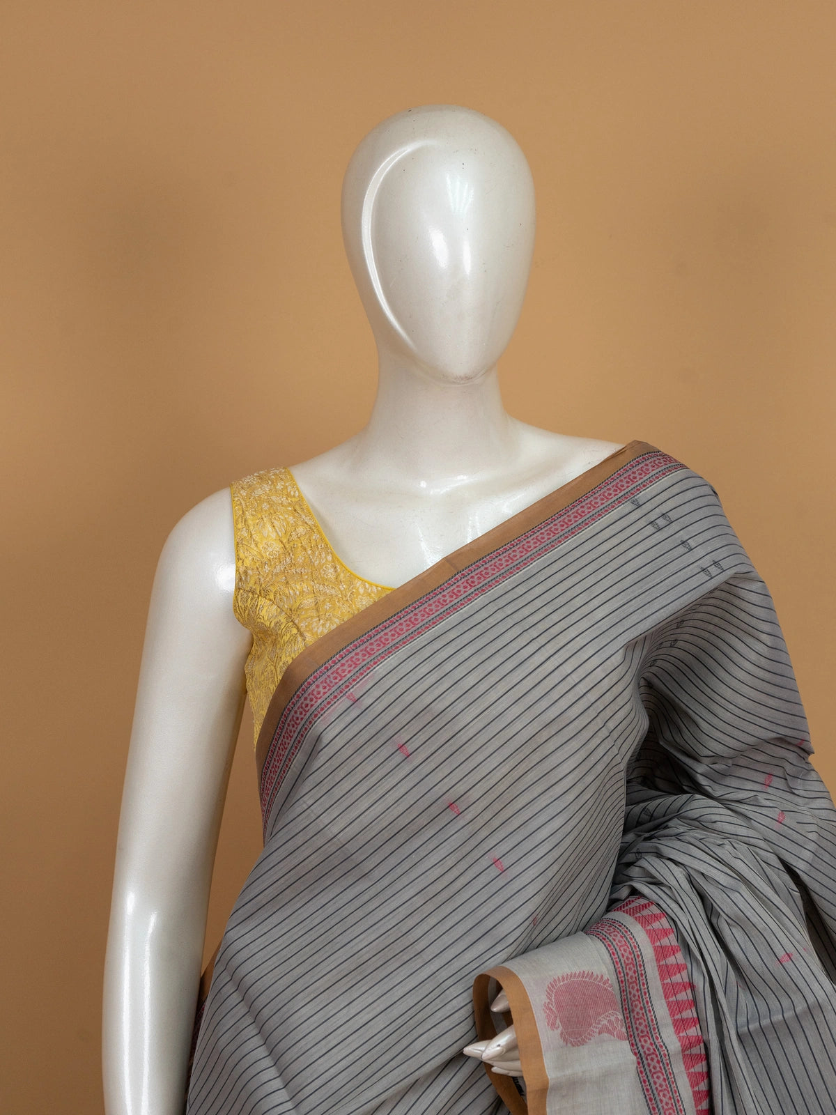 Grey semi raw silk saree with black pinstripes, pink temple border and paisley pallu