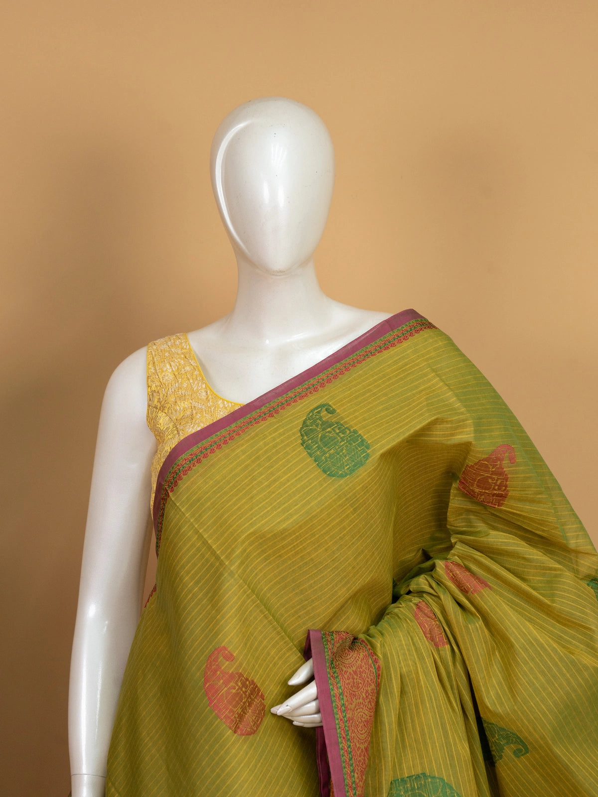 Mehndi green semi raw silk saree with paisley and elephant motifs, contrast maroon border and banded pallu