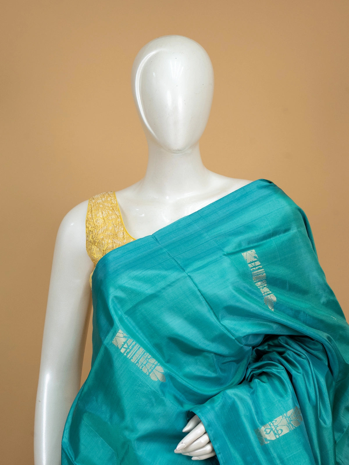 Teal banana silk saree with yellow contrast pallu, silver zari buttas, and matching yellow blouse