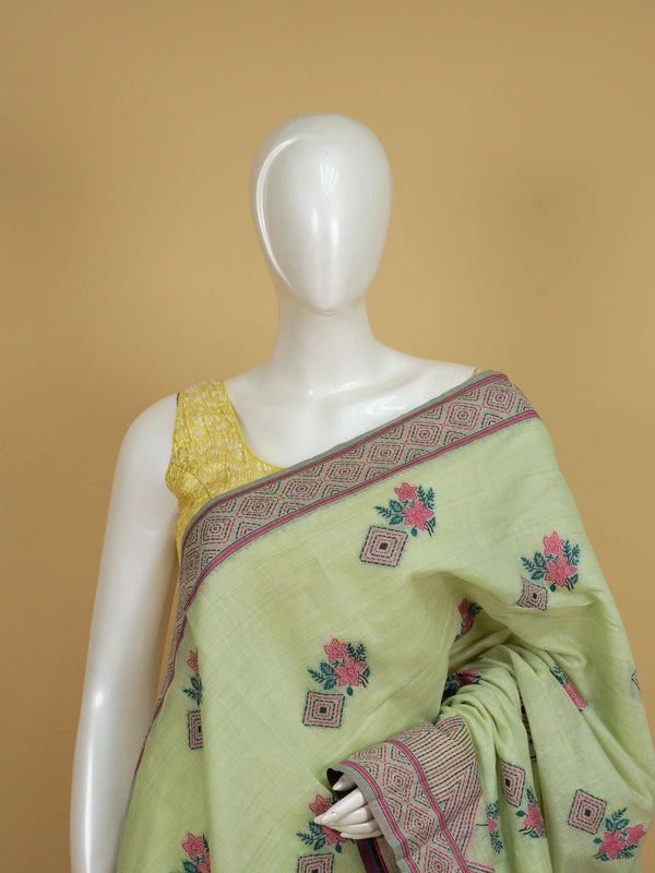 Pastel green linen cotton saree with pink floral print and geometric contrast border