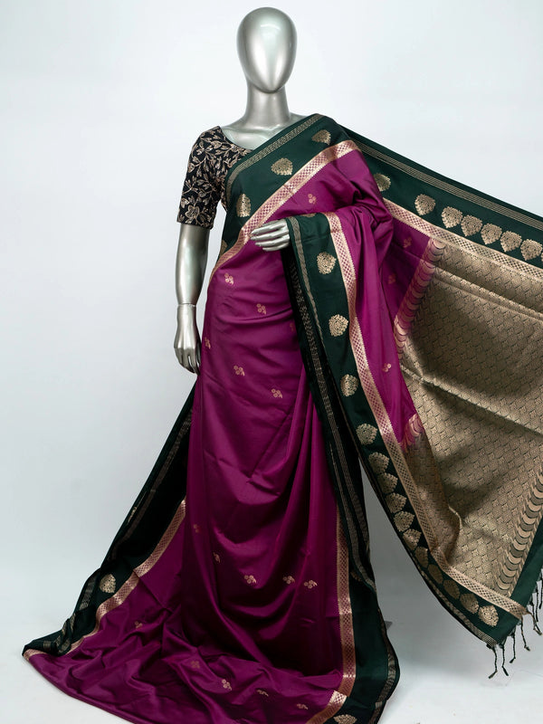 Magenta semi silk saree with dark green gold zari contrast border and floral buttas