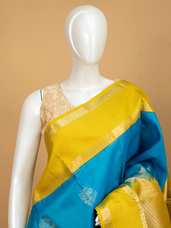 Peacock blue pure Kanchipuram silk saree with contrast yellow gold zari border and floral buttas