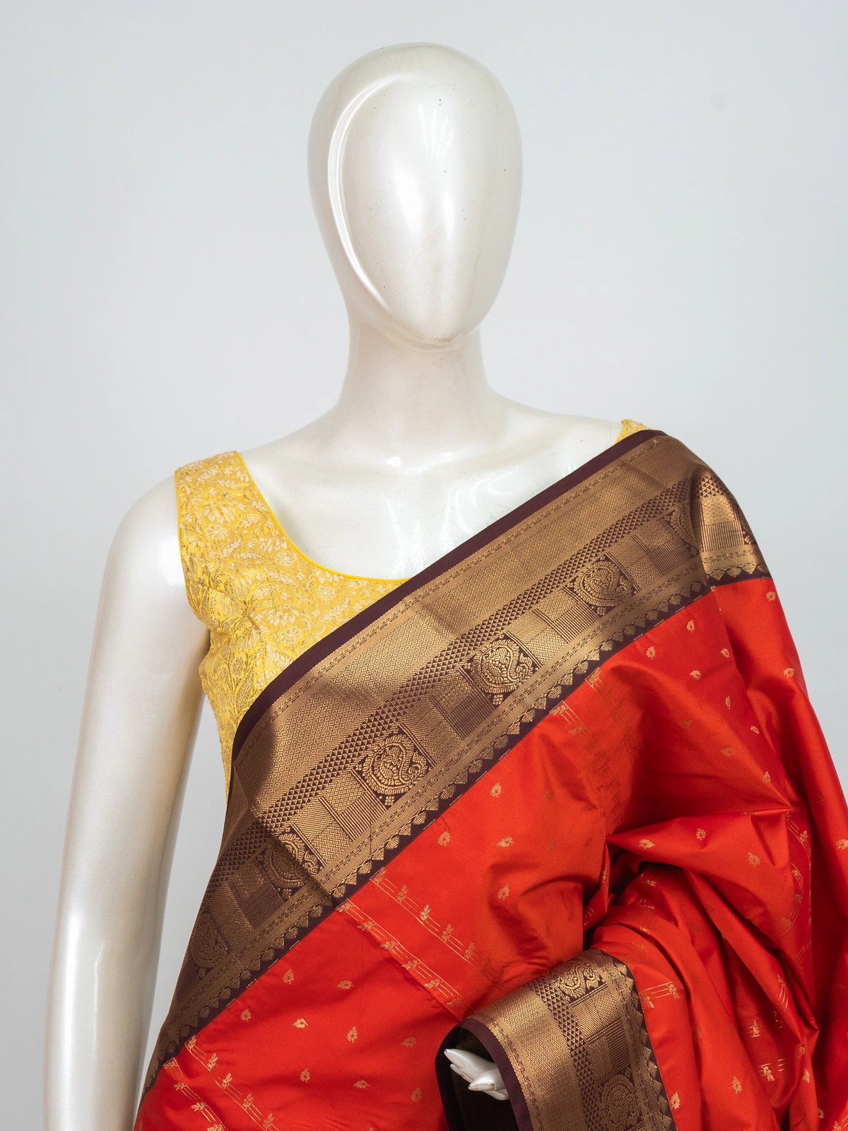 Orange semi silk saree with maroon contrast border and gold zari peacock pallu