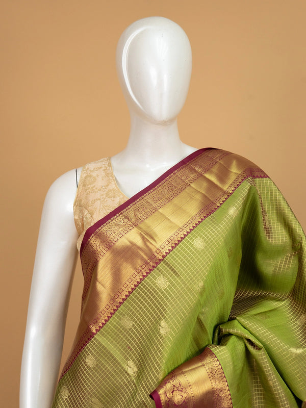 Parrot green pure Kanchipuram silk saree with contrast maroon and gold zari border and pallu