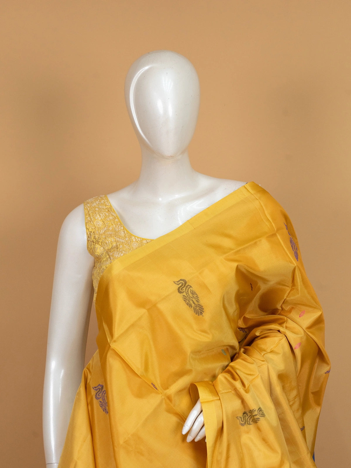 Mustard yellow banana silk saree with royal blue contrast pallu, border and scattered buttas