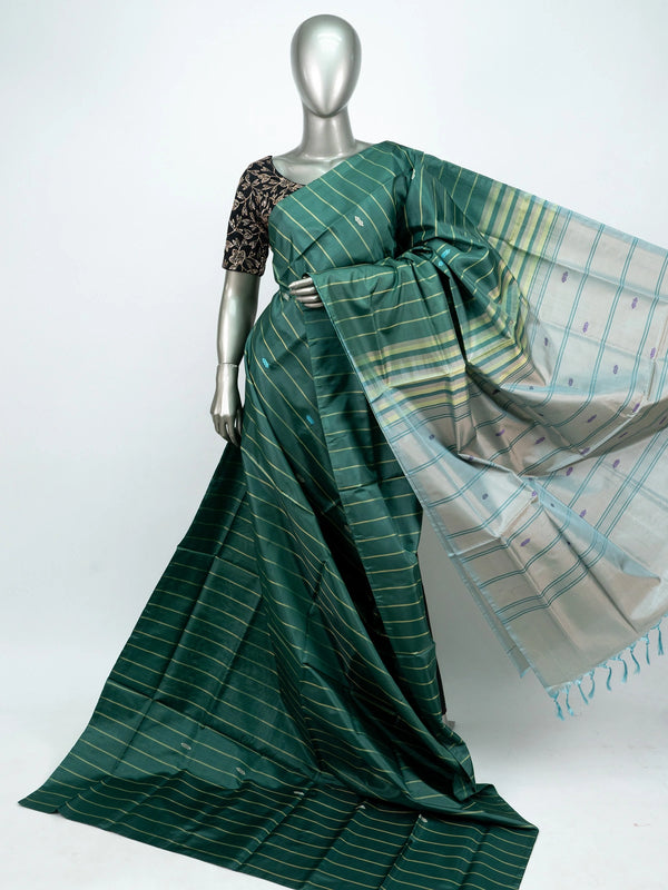 Bottle green banana silk saree with gold zari stripes, woven buti motifs and a contrast silver-grey tasselled pallu