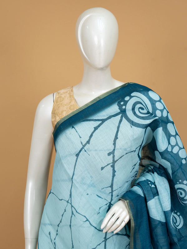 Sky blue and teal batik linen cotton saree with white pebble motifs and gold zari border